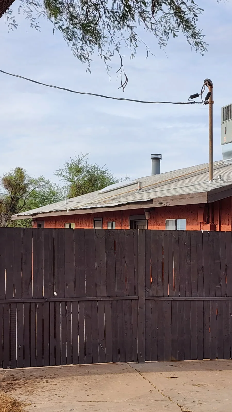 Eave edge with lifted shingles and misaligned drip edge