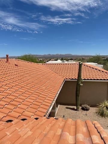 Broken tile roof ridge in Tucson showing wind damage