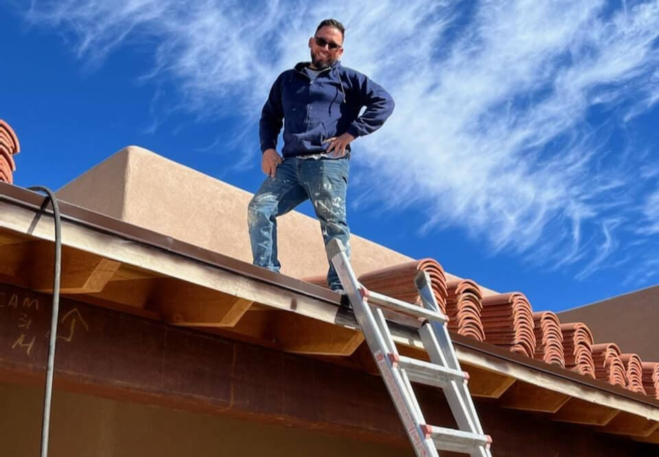 Eddie Guillen, owner of Sunrise Roofers, working on a roof in Tucson, AZ